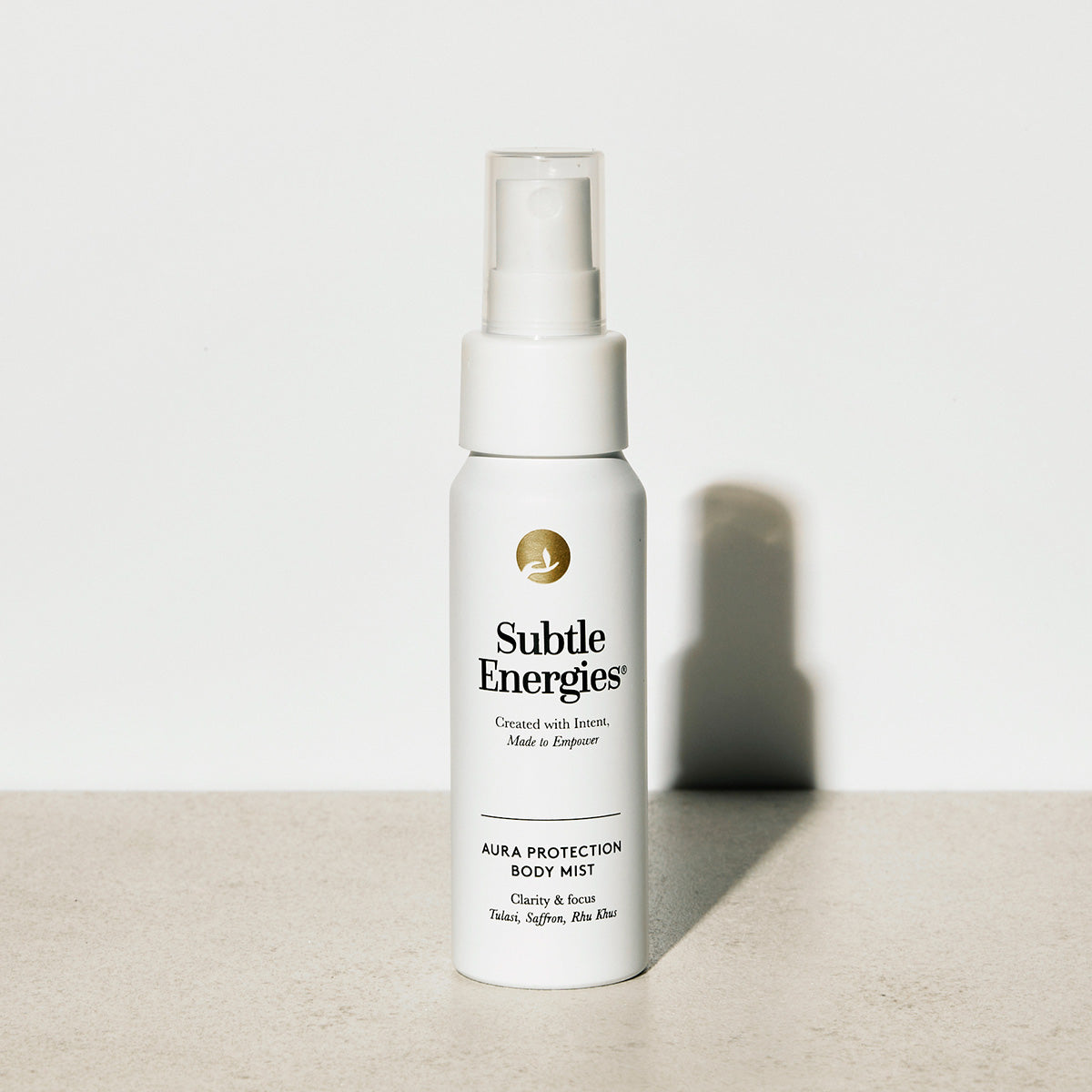 Subtle Energies aura protection body mist bottle on a light surface with a white background