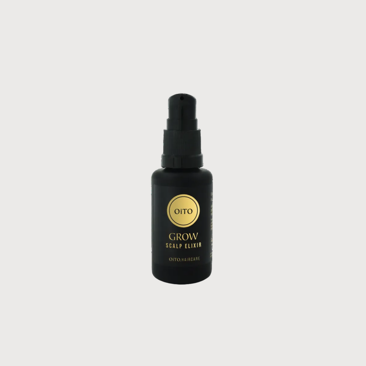 Black spray bottle with gold label on a white background