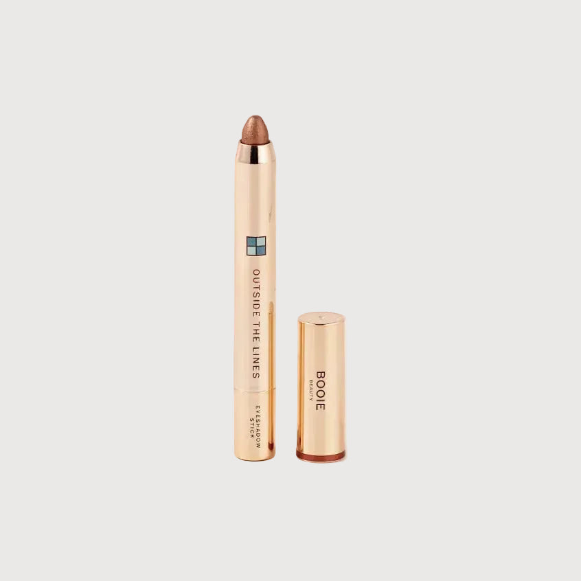 Makeup product with rose gold casing on a light pink background
