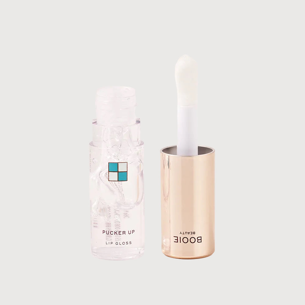 Lip gloss container with a clear cover on a light background