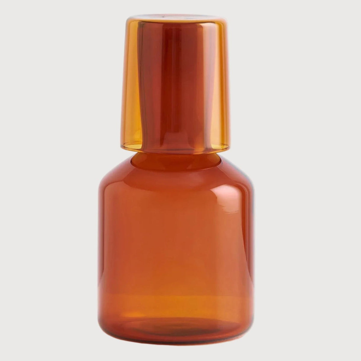 Amber glass bottle on a light gray background