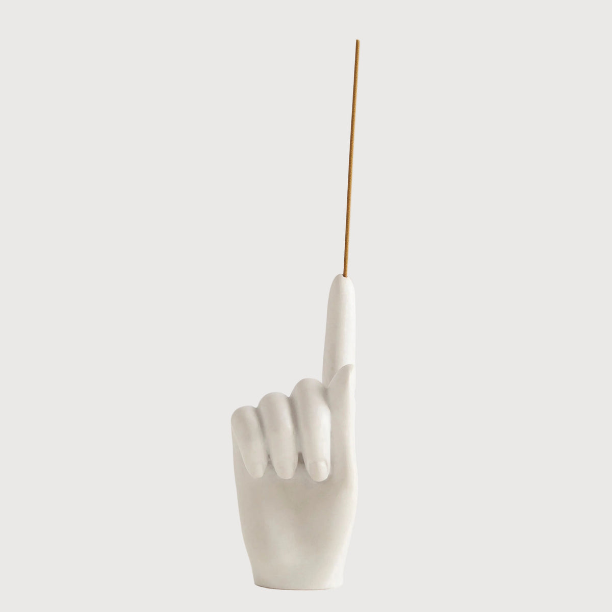 White ceramic hand sculpture with a single finger pointing upwards on a white background