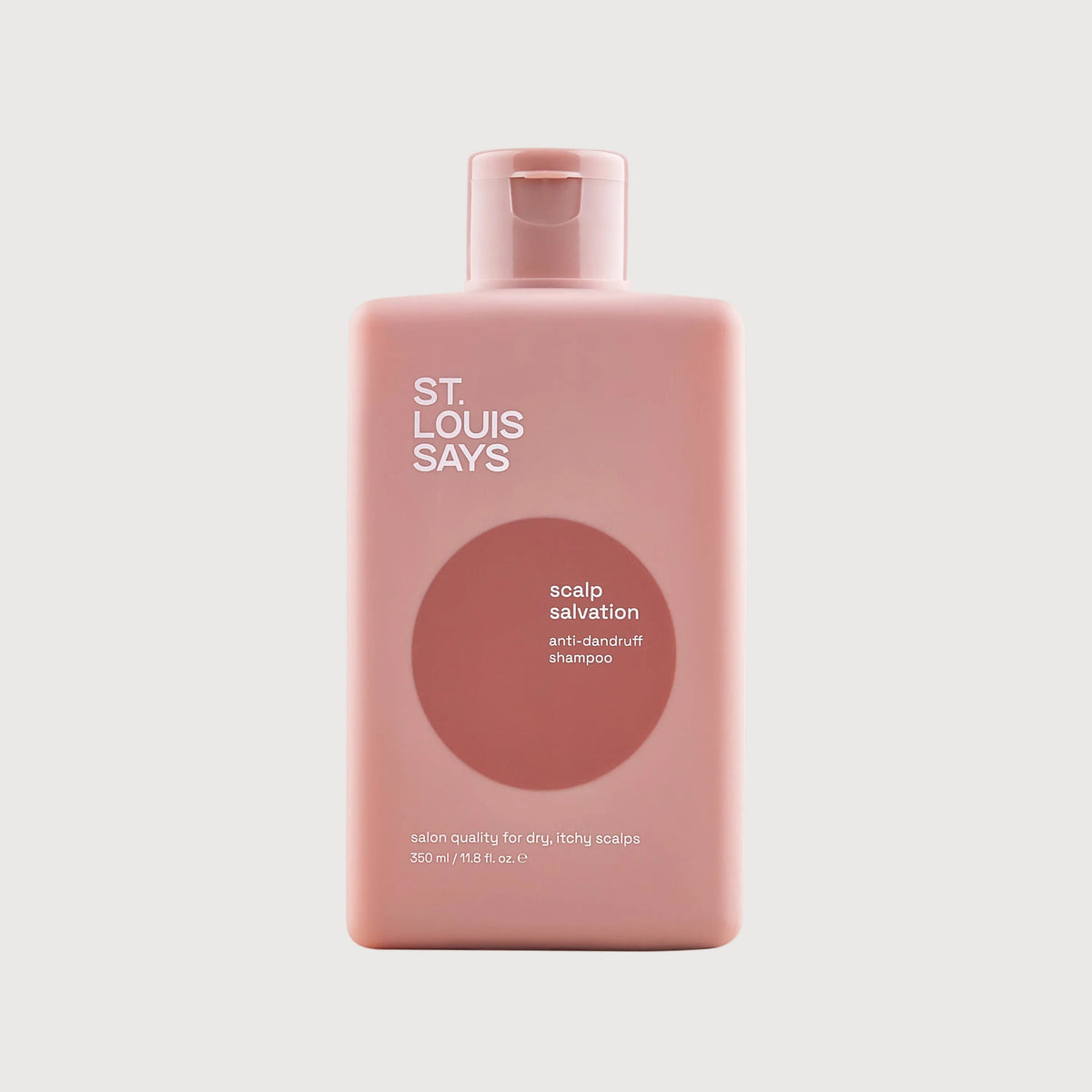 Pink bottle of 'St. Louis Says' scalp salvation product on a light gray background