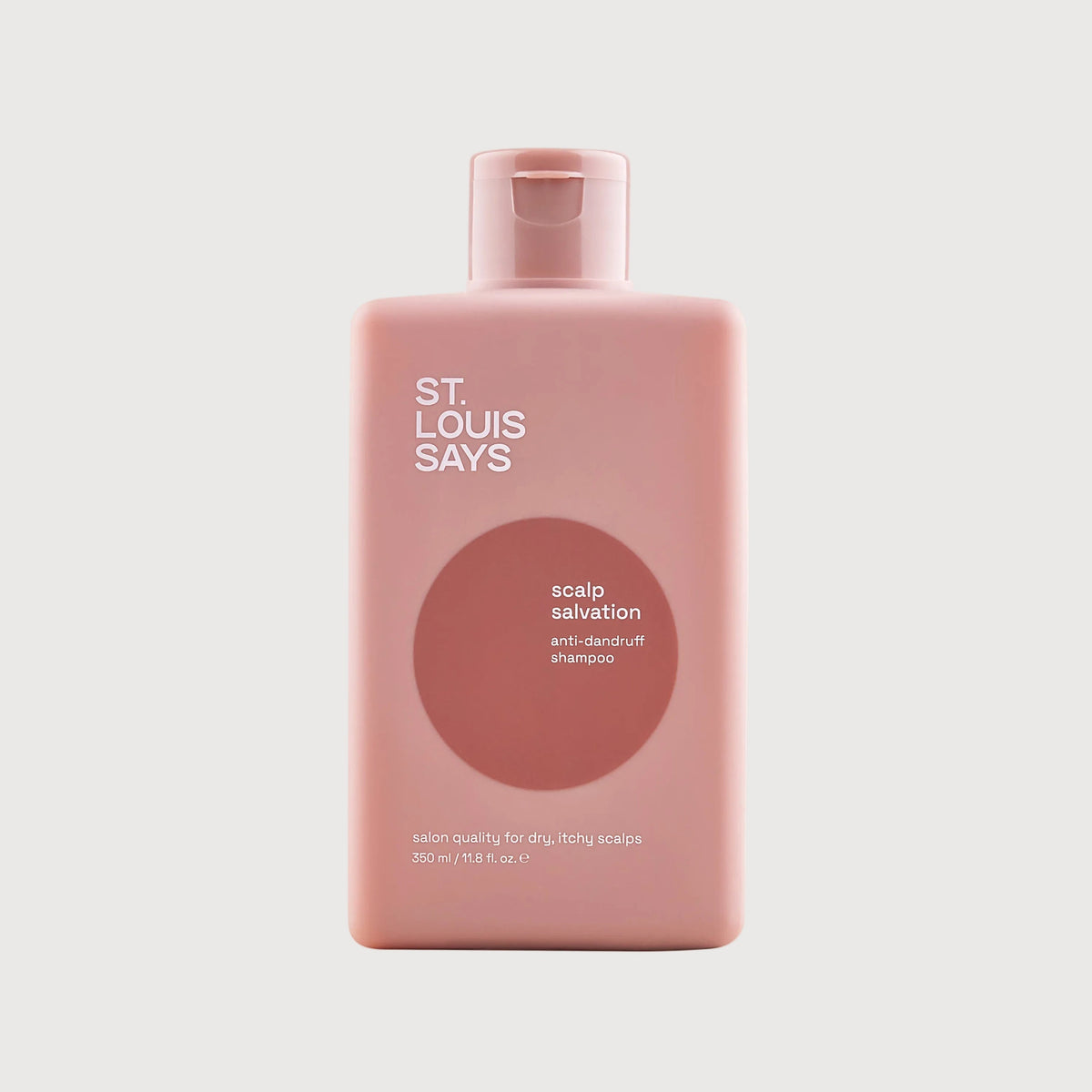 Pink bottle of 'St. Louis Says' scalp salvation product on a light gray background
