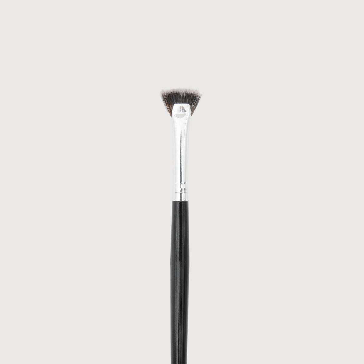Makeup brush with black handle and bristle head on a white background