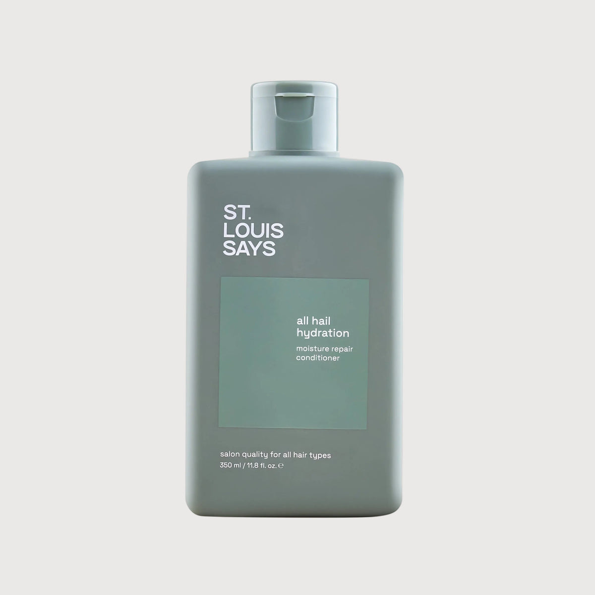 Bottle of 'St. Louis Says' hair product on a light gray background
