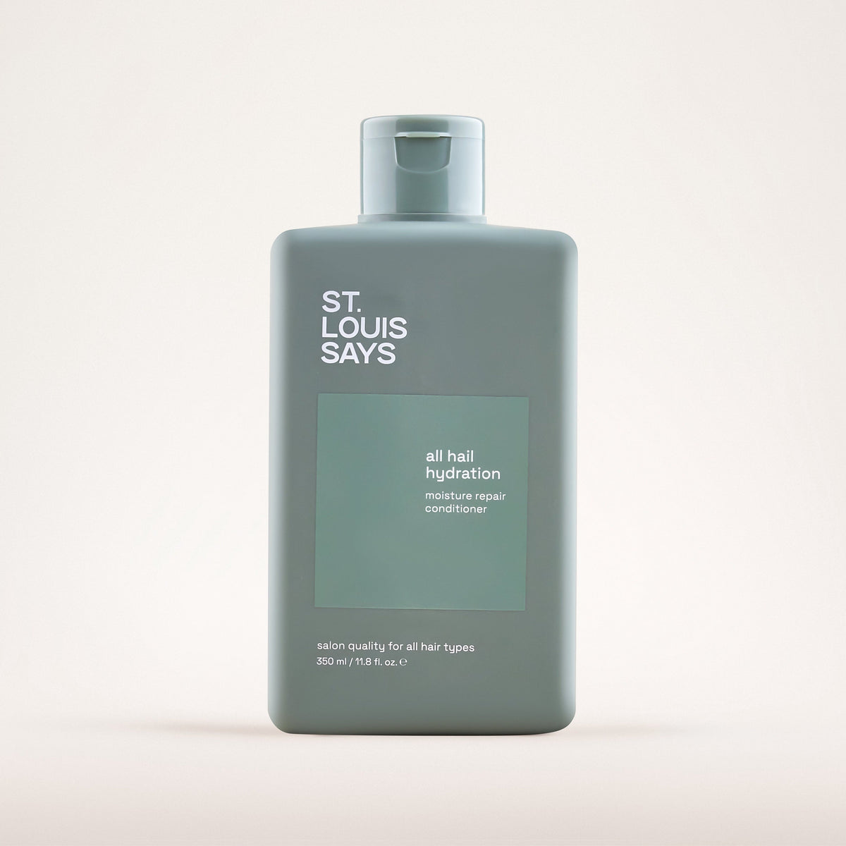 Bottle of 'St. Louis Says' hair product on a white background