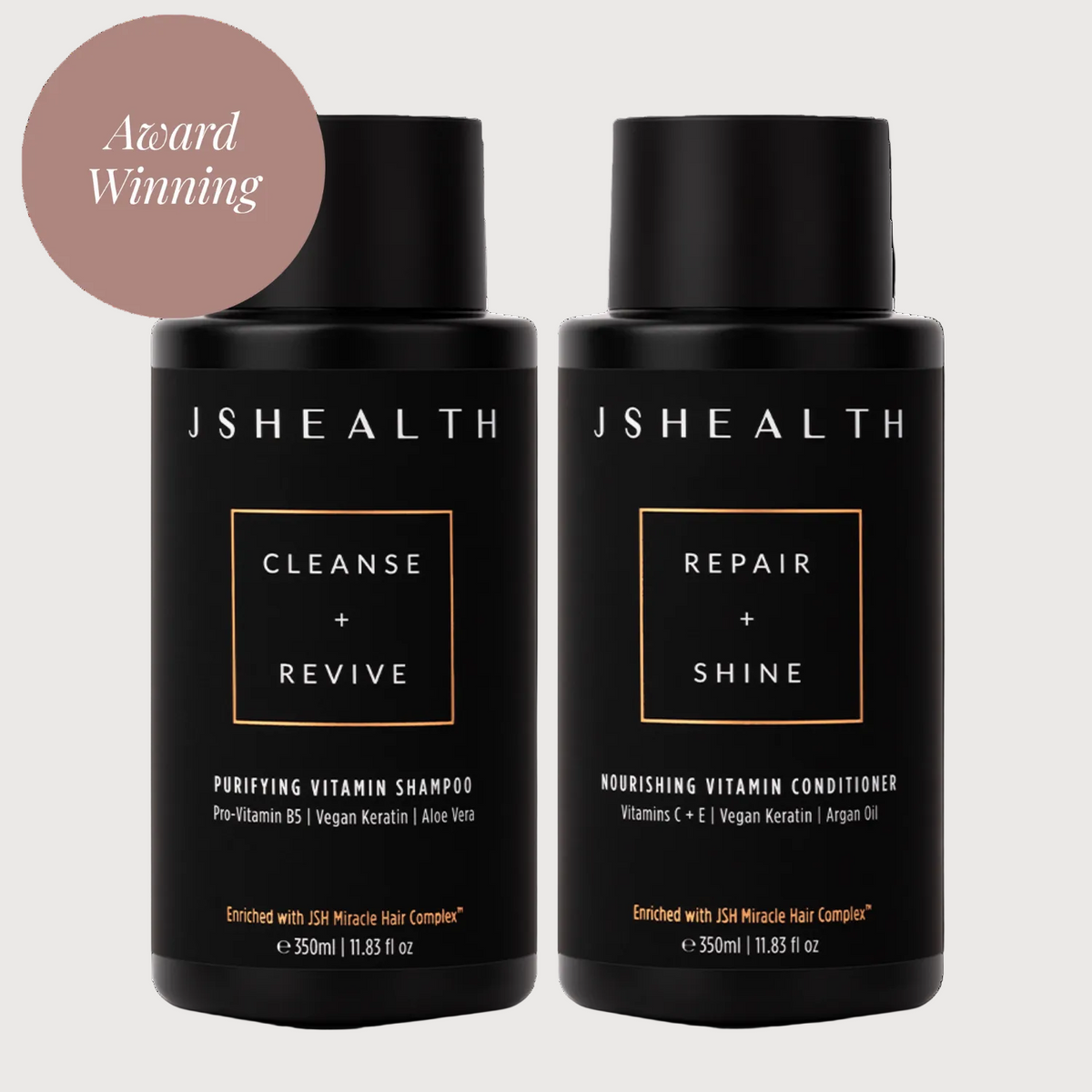 Two JSHealth hair care bottles, one for cleanse and revive, the other for repair and shine, on a white background.