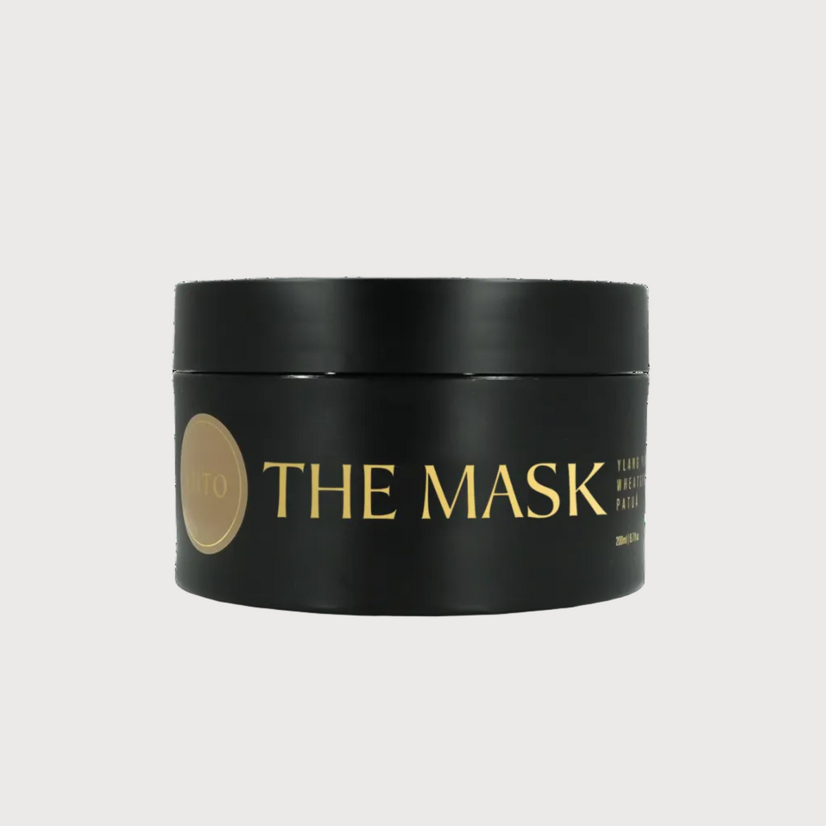 Black container of 'THE MASK' with gold text on a white background