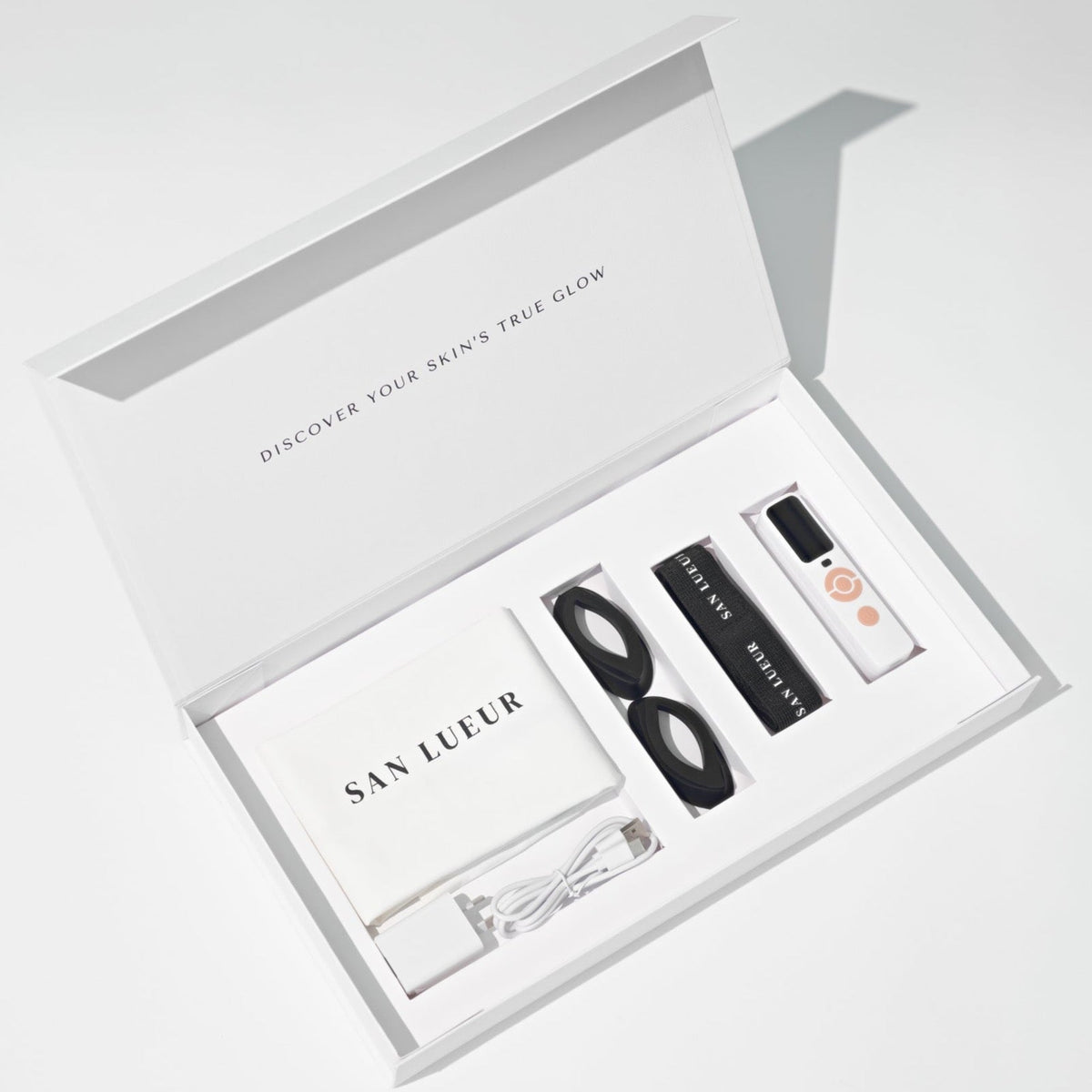 Skincare product set in a white box with 'San Lueur' branding on a light gray background.