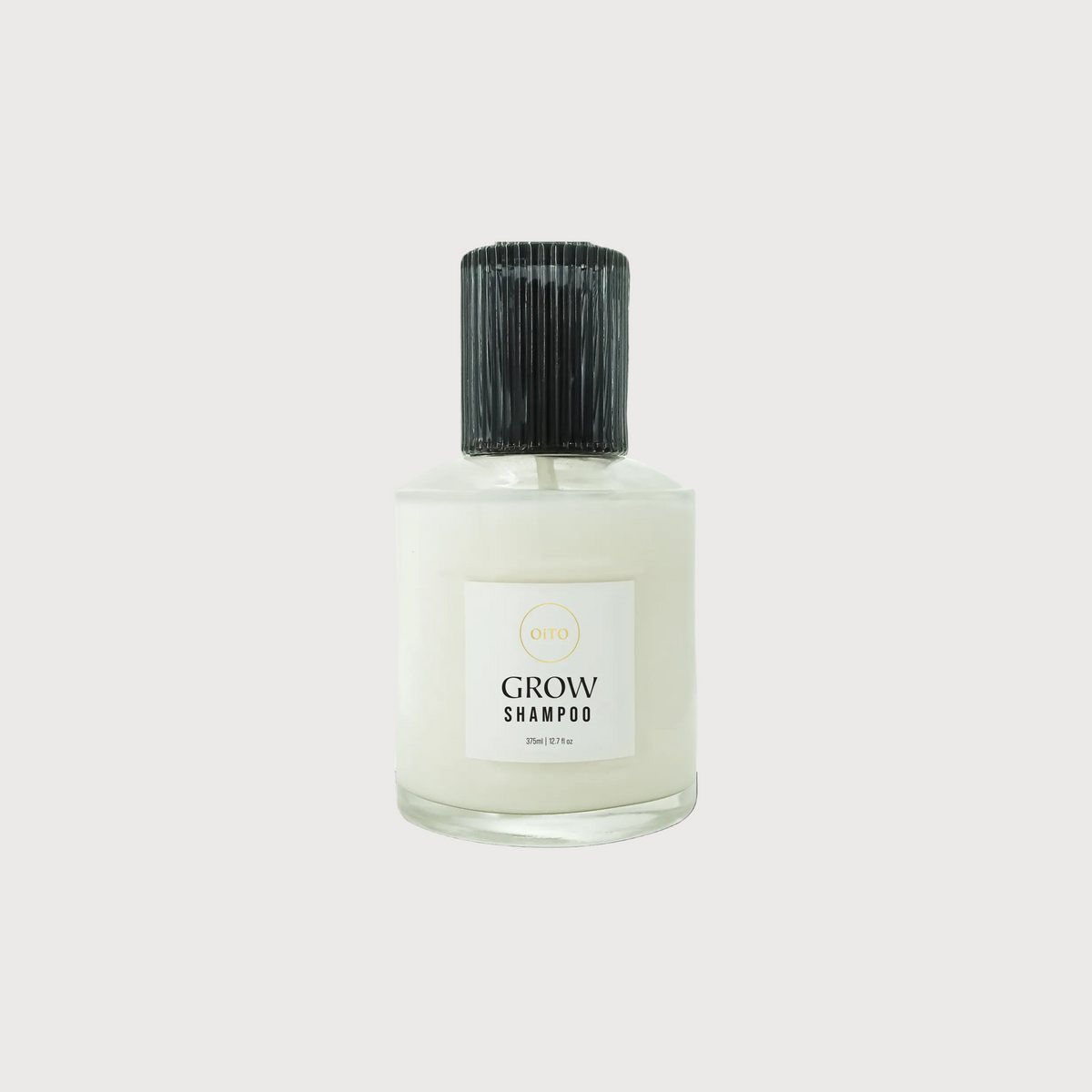 Bottle of Grow shampoo on a white background