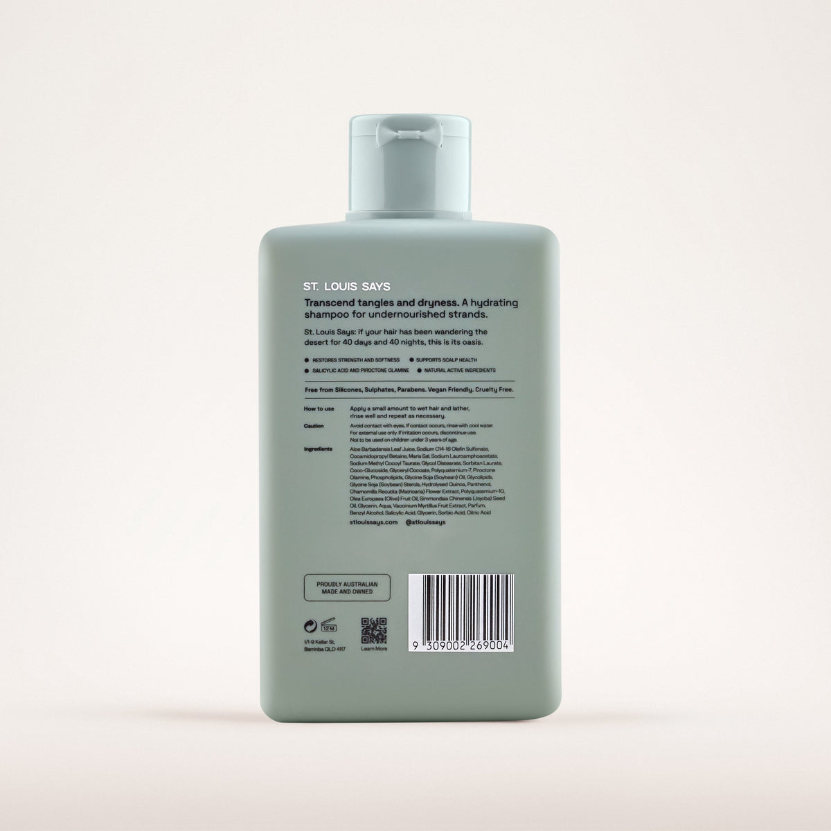Green shampoo bottle with label on a light gray background