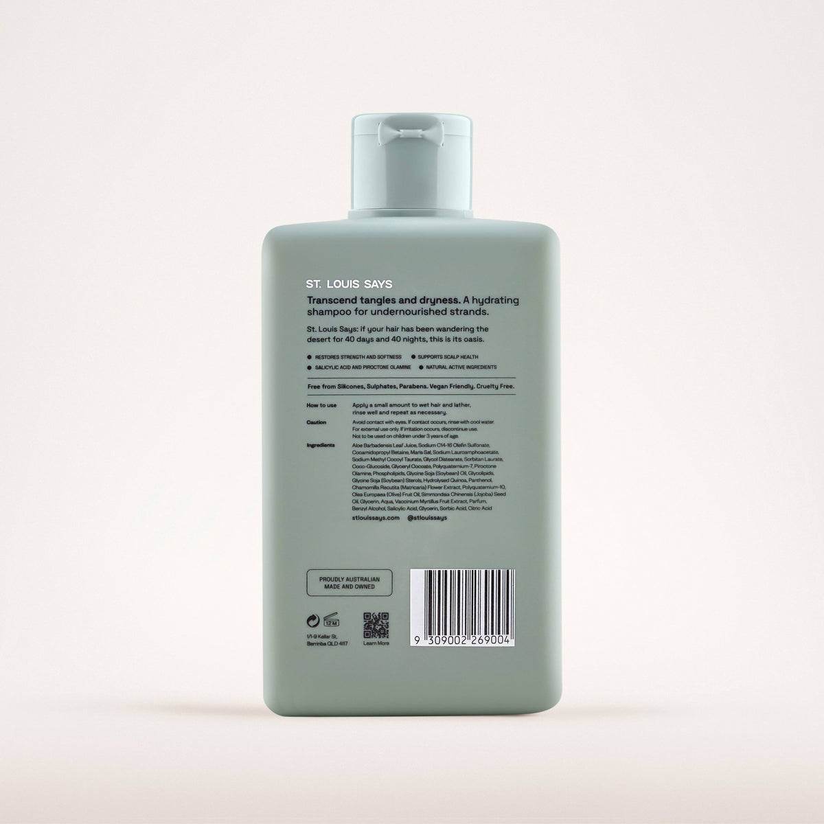 Green shampoo bottle with label on a light gray background