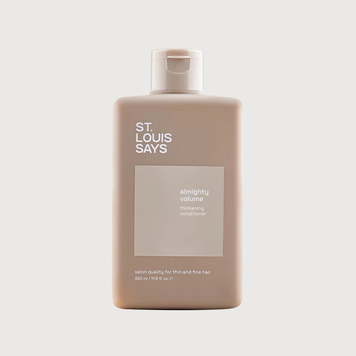 Shampoo bottle labeled 'St. Louis Says' on a light beige background