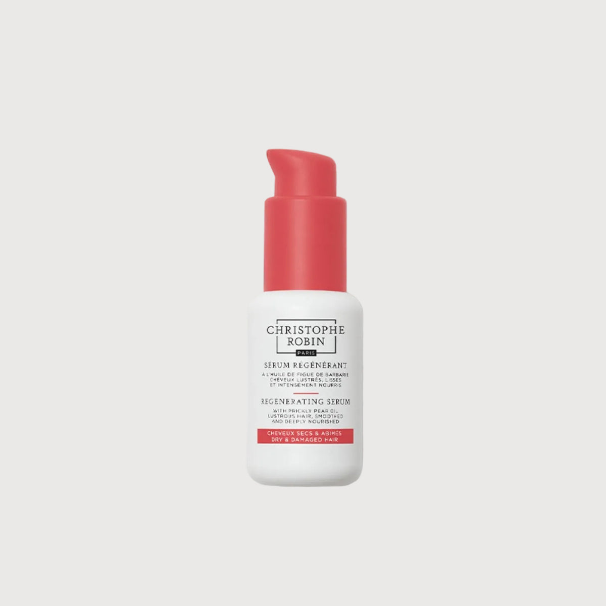 Skincare serum bottle with red cap and white label on a white background