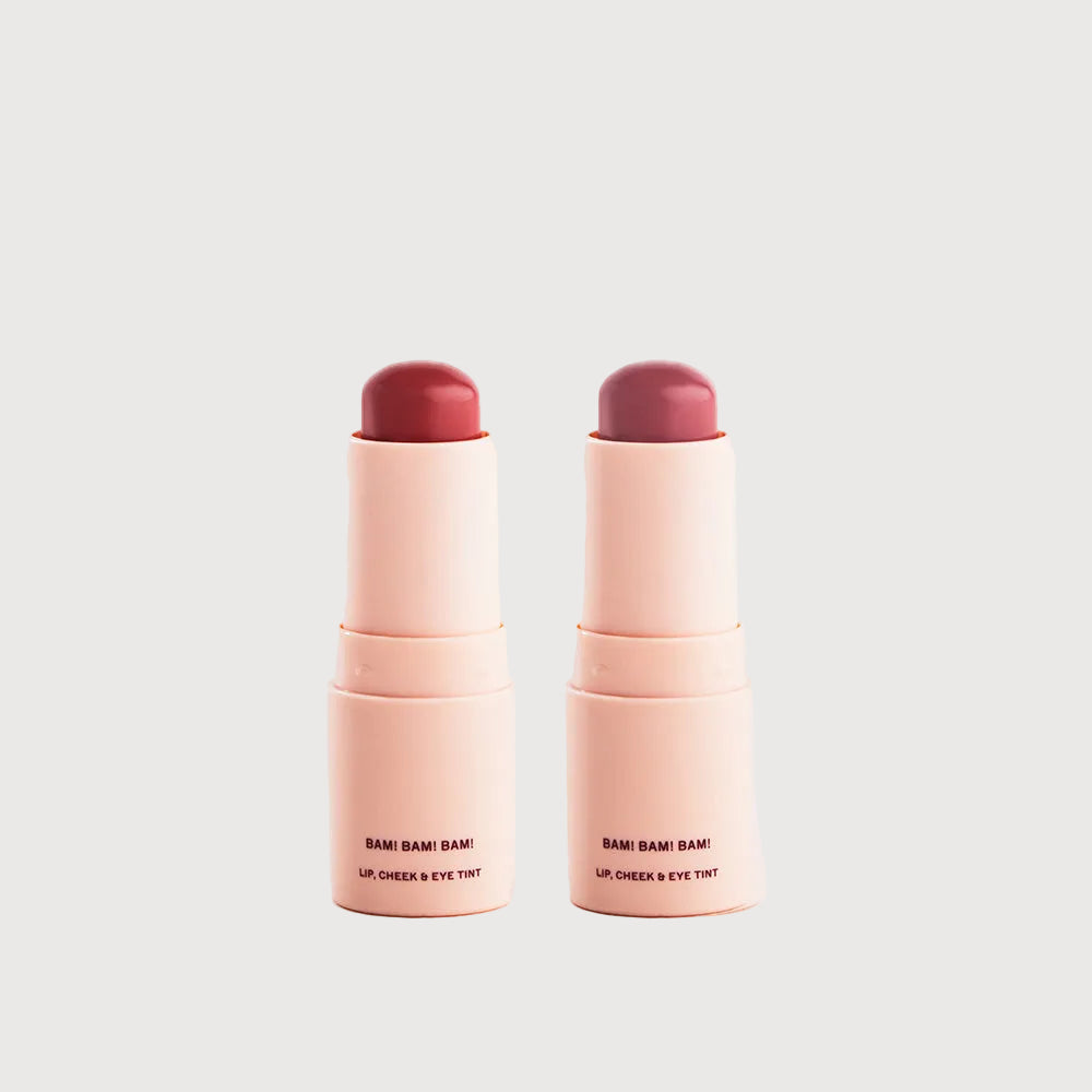 Two lip, cheek, and eye tint sticks with a neutral background
