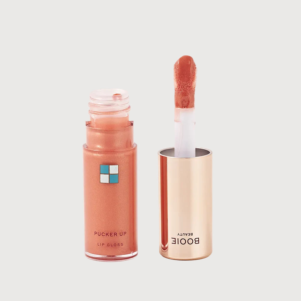 Lip gloss with open cap on a white background