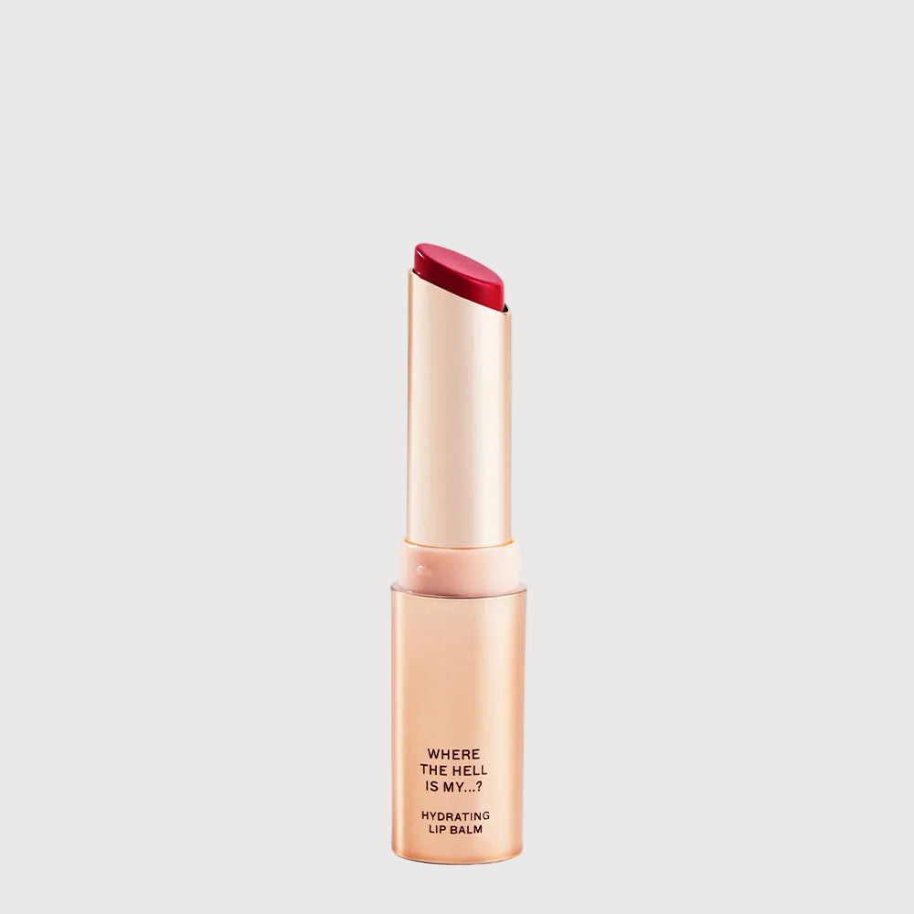 Lip balm with red cap and beige body on a light gray background