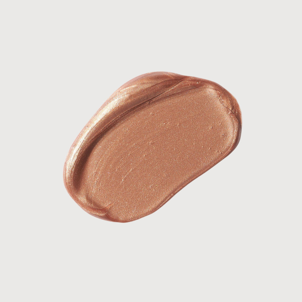 Bronze-colored makeup swatch on a light gray background