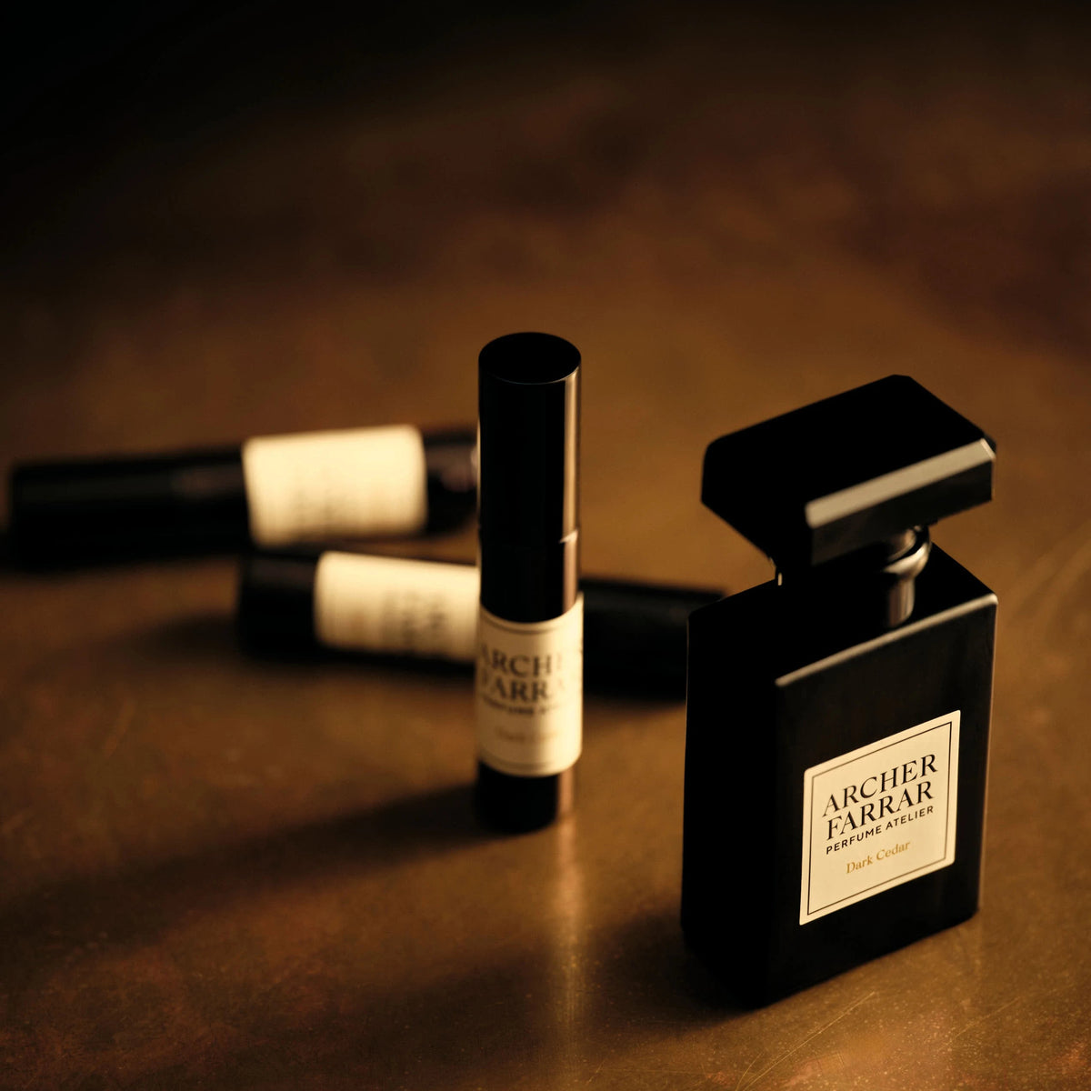 Black Arlier Farrar perfume bottle on a brown surface