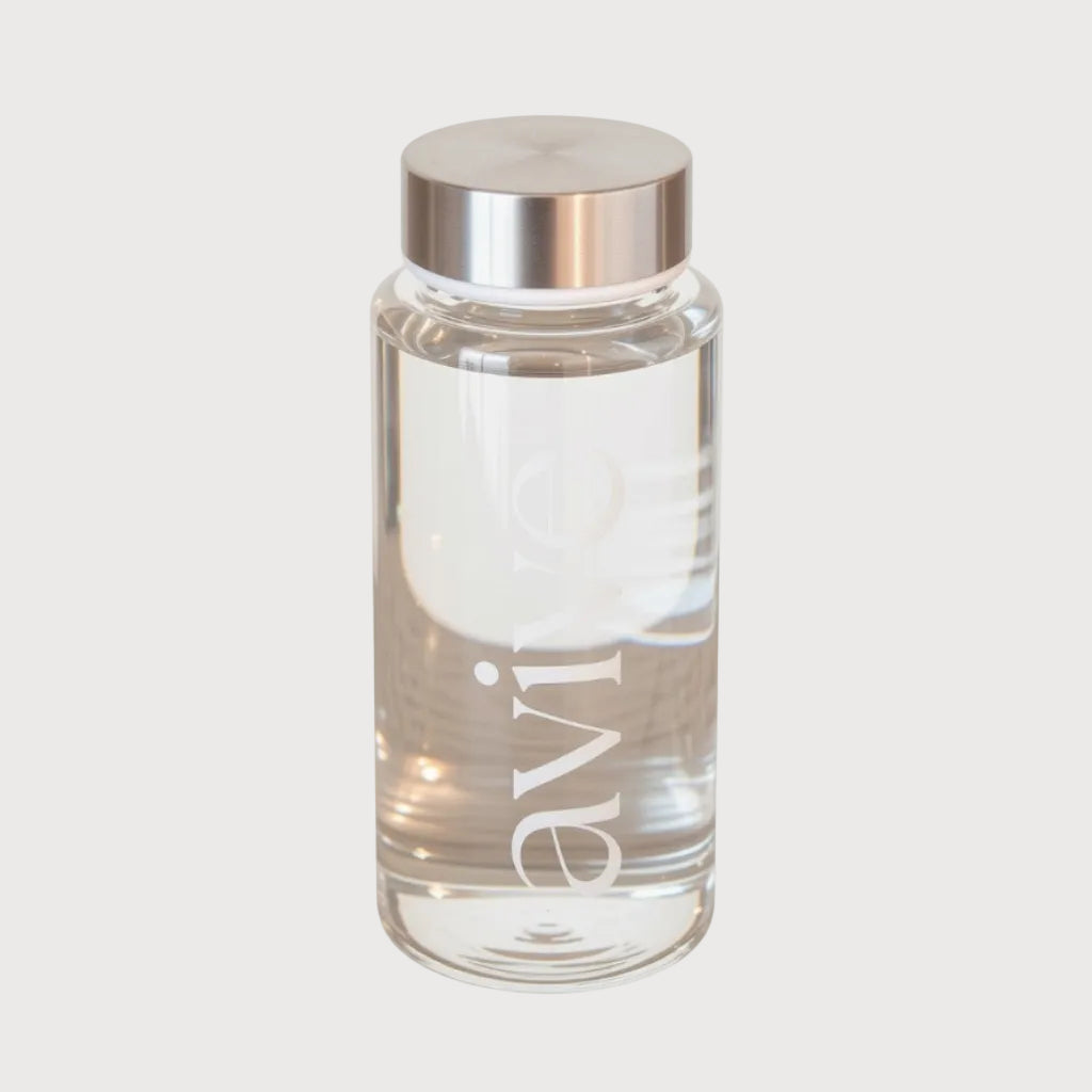 A clear glass water bottle with a brushed silver metallic cap, featuring the brand name 'avive' printed vertically in white on the front, set against a plain white background.