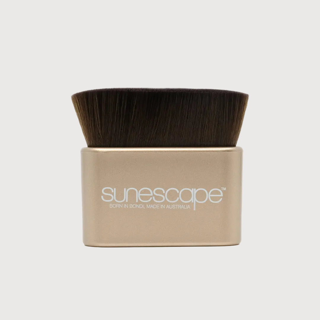 Cosmetic brush with brown bristles in a beige handle on a white background, branded 'sunescape'.
