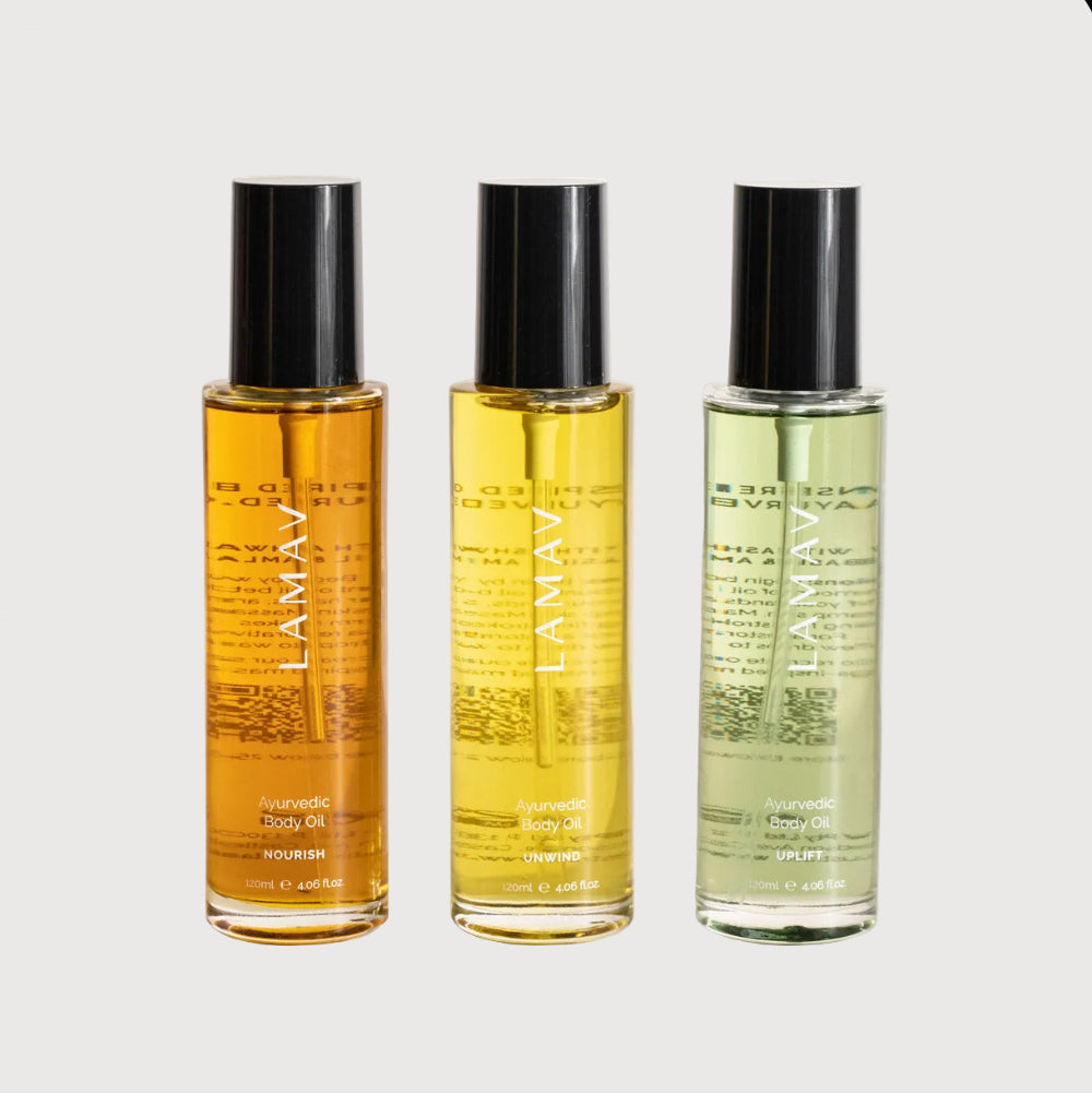 Three bottles of LAMAV body oils on a light background