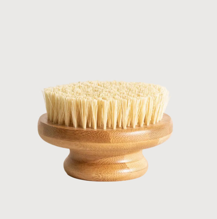 Wooden brush with bristles on a light background