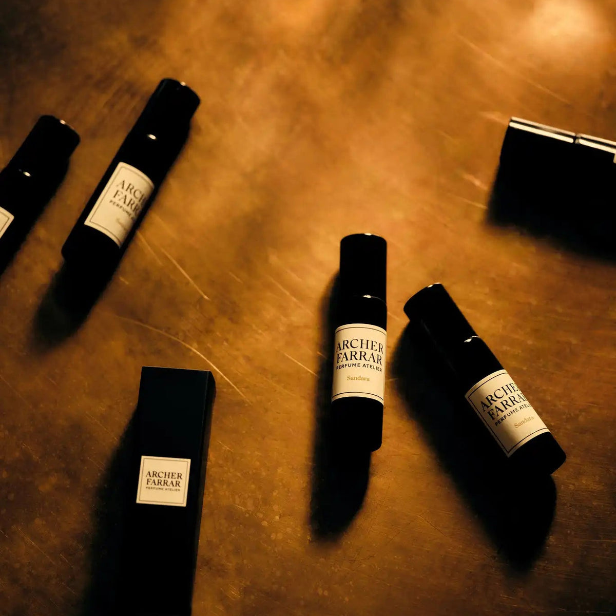 Black bottles with labels on a textured surface