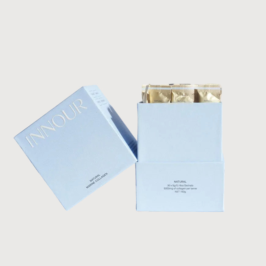 Light blue gift box with gold interior contents on a white background