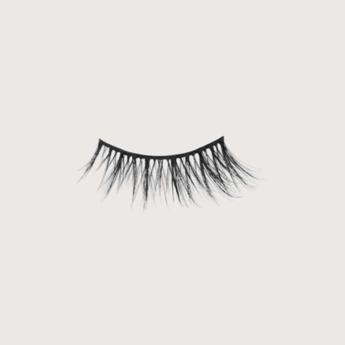 Pair of false eyelashes on a light gray background
