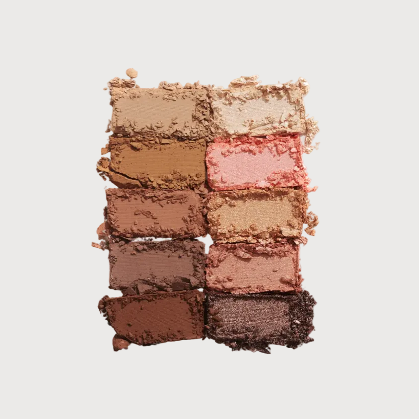 Makeup palette with various shades of eyeshadow on a light gray background