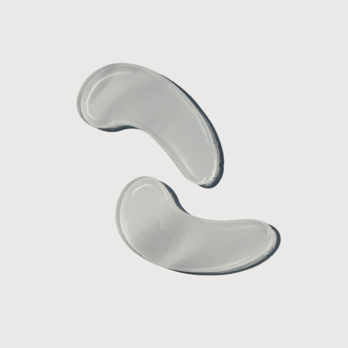 Two gray silicone gel pads on a white background