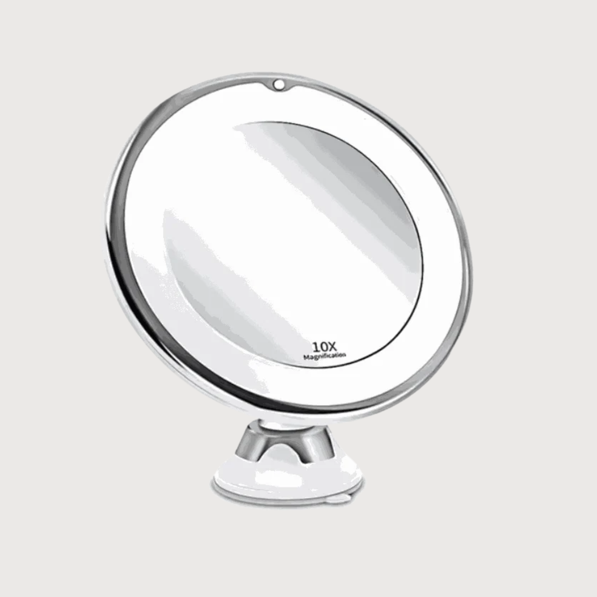 Round makeup mirror with 10x magnification on a white background
